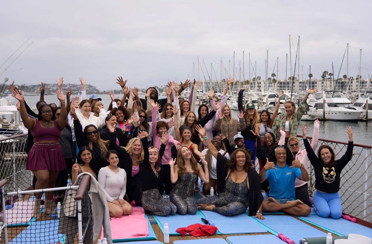 Yacht Pilates retreat group waving on the yacht deck